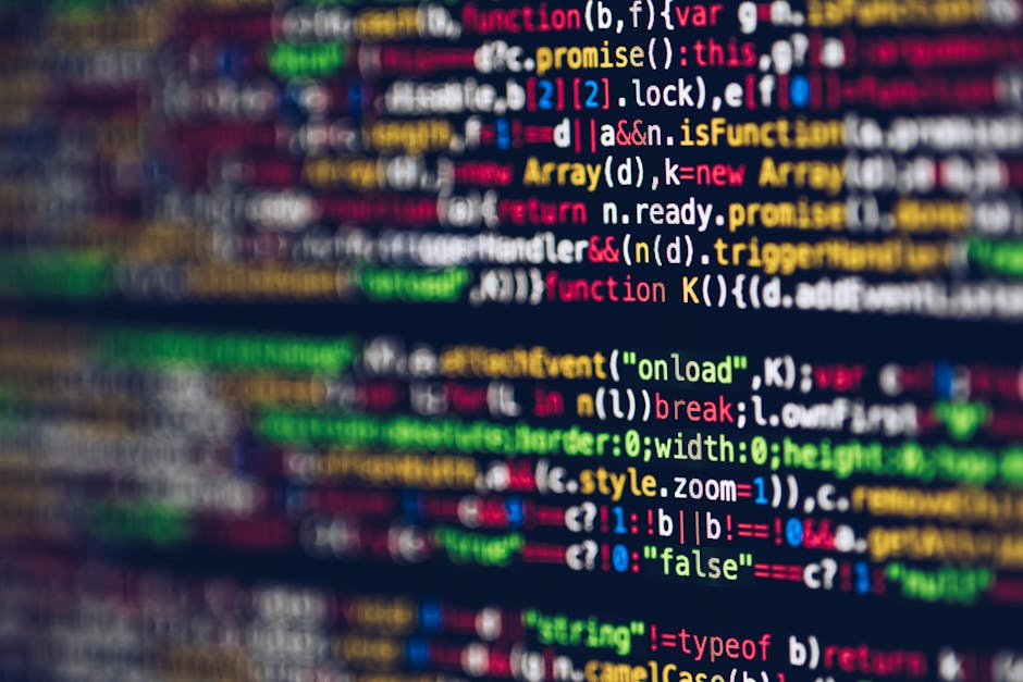 Close-up view of a computer screen displaying lines of HTML and coding syntax in various colours, including tags, attributes, and text, associated with website development or editing. The code appears